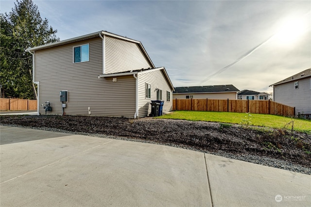 back of property with fence and a yard