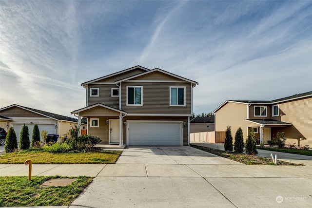 view of front facade featuring a garage, driveway, and fence