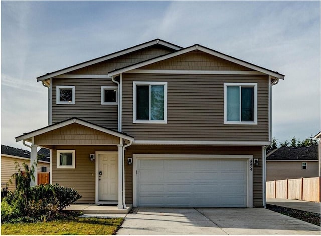 view of front of property with a garage, driveway, and fence