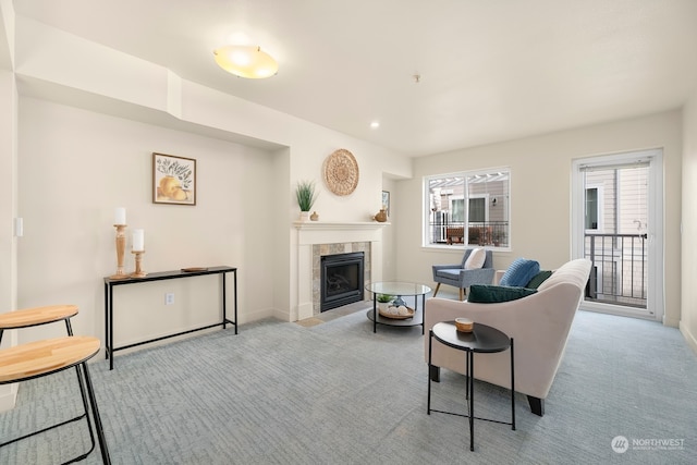 carpeted living room with a tile fireplace