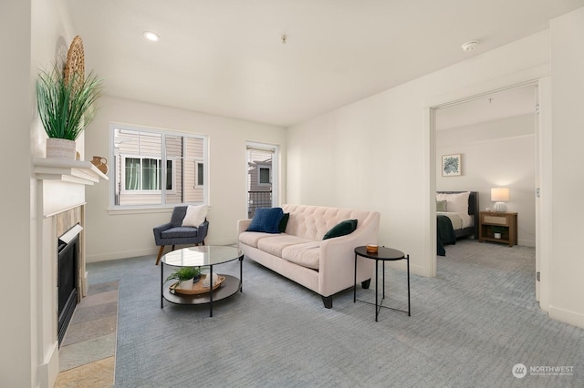 1545NW 57th St Unit 505, Seattle, WA 98107 - living area with baseboards, light carpet, and a fireplace with flush hearth