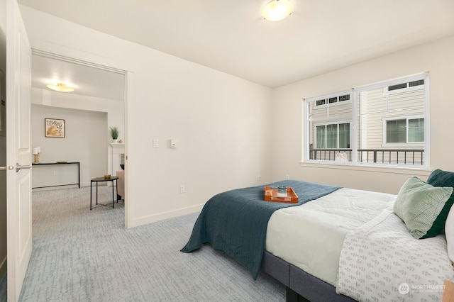 bedroom featuring light colored carpet