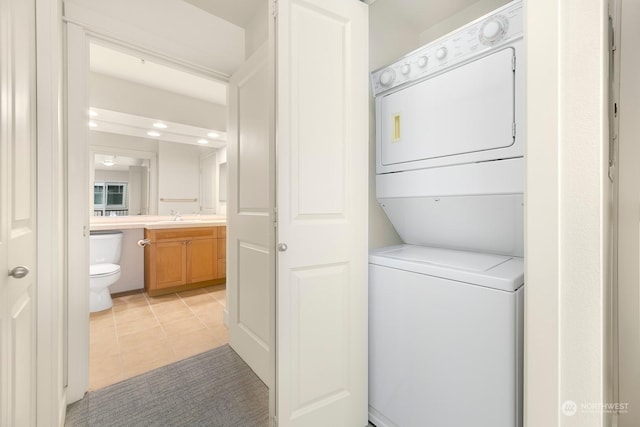 1545NW 57th St Unit 505, Seattle, WA 98107 - washroom with stacked washer / drying machine, light tile patterned floors, and recessed lighting