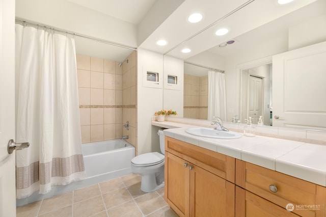 full bathroom featuring tile patterned floors, shower / tub combo with curtain, vanity, and toilet