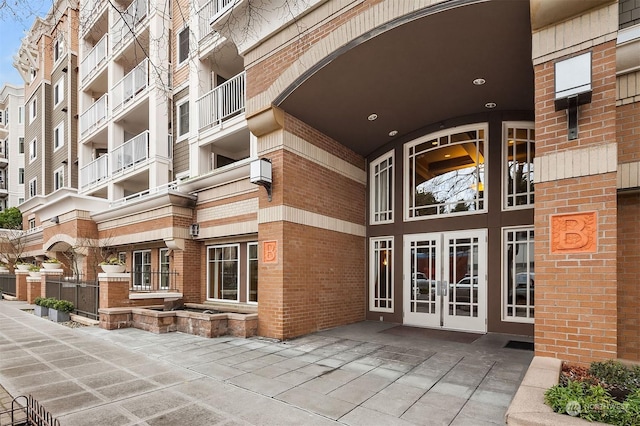 1545NW 57th St Unit 505, Seattle, WA 98107 - property entrance featuring french doors, brick siding, and a wall mounted air conditioner