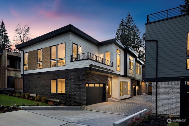 view of front facade with a balcony and a garage