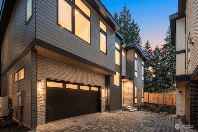 property exterior at dusk with a garage