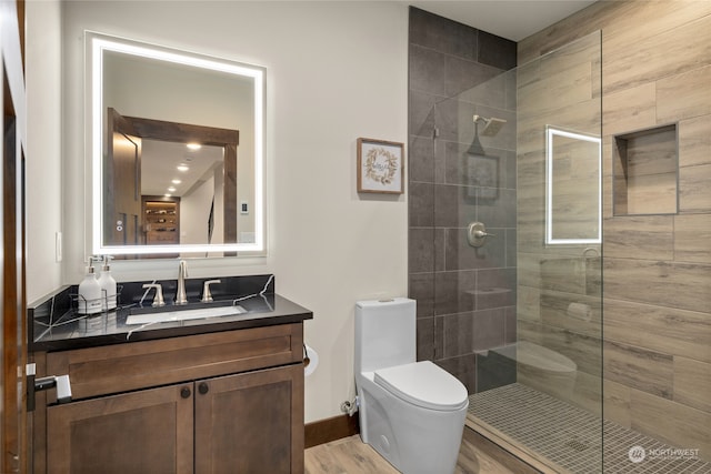 bathroom featuring an enclosed shower, wood-type flooring, toilet, and vanity