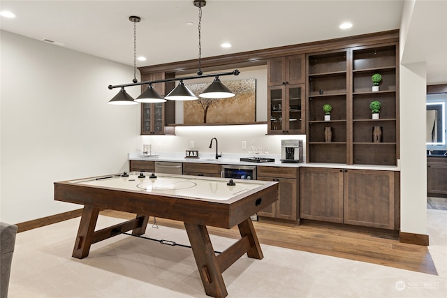 game room featuring light wood-type flooring and wine cooler