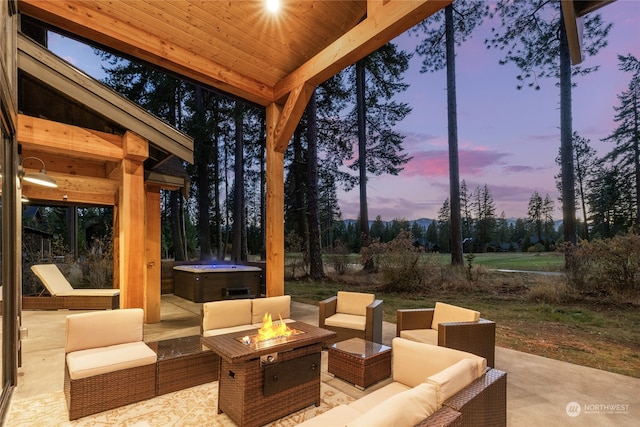 patio terrace at dusk featuring an outdoor living space with a fire pit