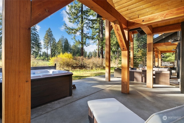 view of patio featuring a hot tub and an outdoor living space