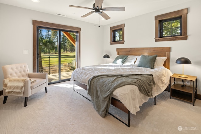 bedroom featuring access to outside, light colored carpet, and ceiling fan