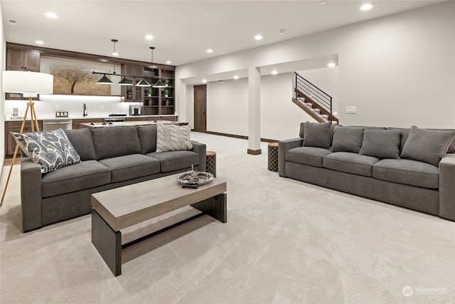 carpeted living room with sink