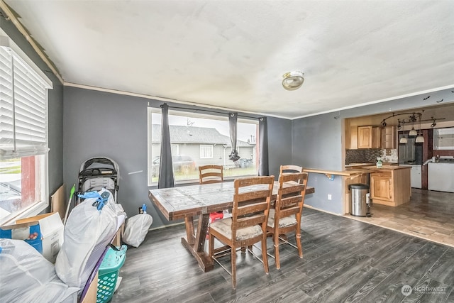 dining room with dark hardwood / wood-style floors, crown molding, and washer / clothes dryer