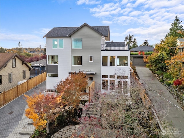 back of property featuring a balcony