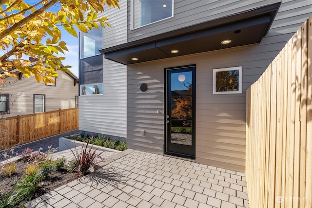 property entrance featuring a patio