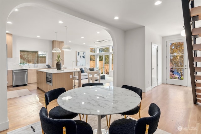 dining space featuring light wood-type flooring and a wealth of natural light