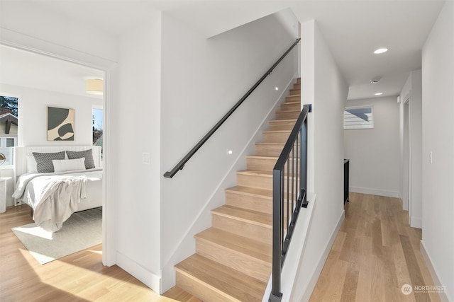 stairs featuring hardwood / wood-style floors