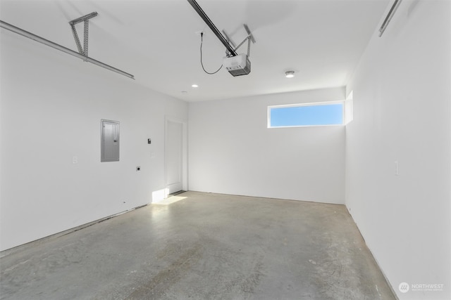 garage featuring electric panel and a garage door opener