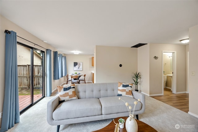 living room with plenty of natural light and light hardwood / wood-style floors