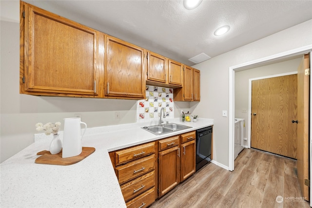 kitchen with a textured ceiling, sink, black dishwasher, and light hardwood / wood-style flooring