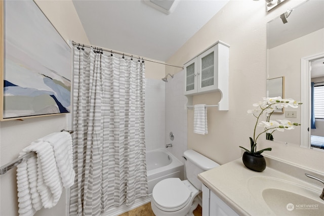 full bathroom featuring vanity, shower / bath combo with shower curtain, and toilet