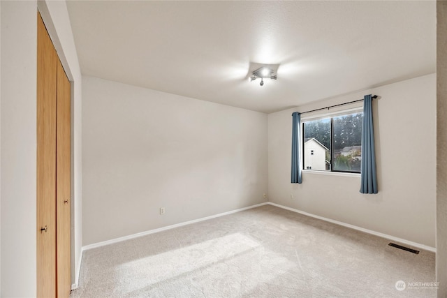 1302 3rd St SE Unit 1, Auburn, WA 98002 - unfurnished bedroom featuring carpet flooring and baseboards