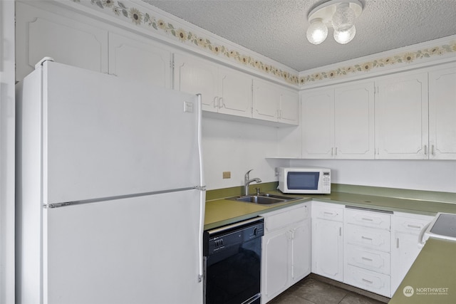 kitchen with white appliances, a textured ceiling, sink, and white cabinetry