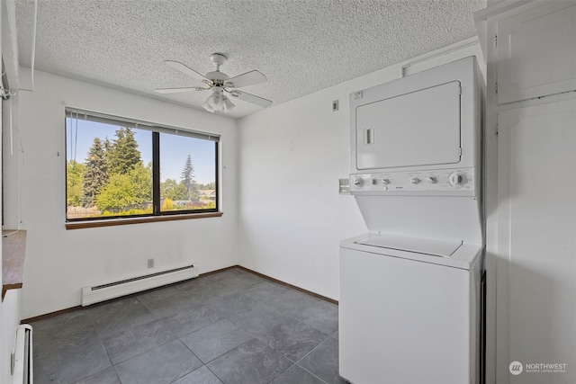 laundry room with ceiling fan, stacked washer and dryer, baseboard heating, and a textured ceiling