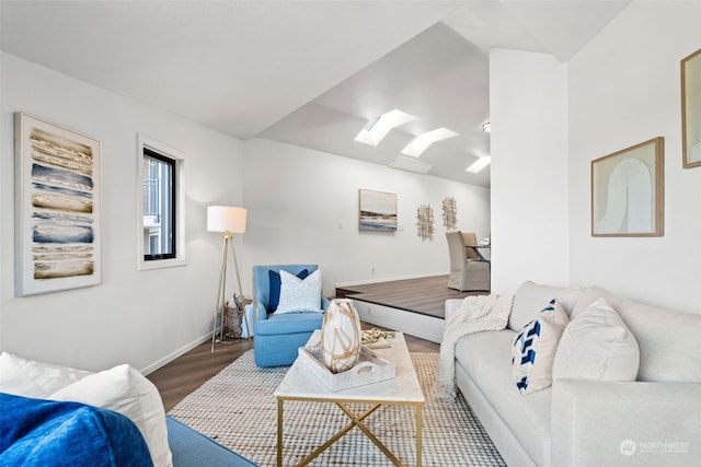 living room with hardwood / wood-style floors and a skylight