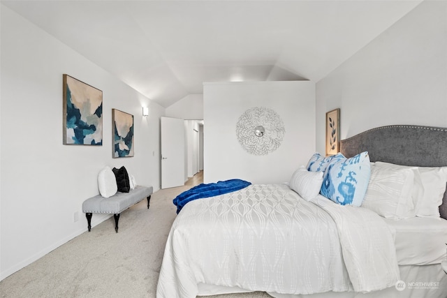 bedroom featuring vaulted ceiling and carpet