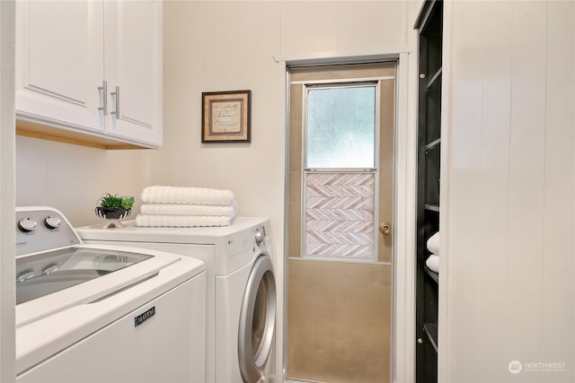 clothes washing area featuring cabinets and independent washer and dryer