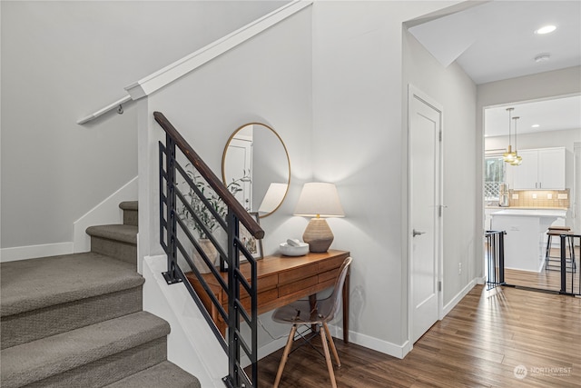 stairway featuring hardwood / wood-style floors