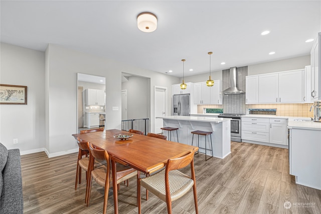 dining area featuring sink and light wood-type flooring