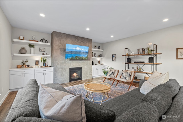 living room with dark hardwood / wood-style flooring and a tile fireplace