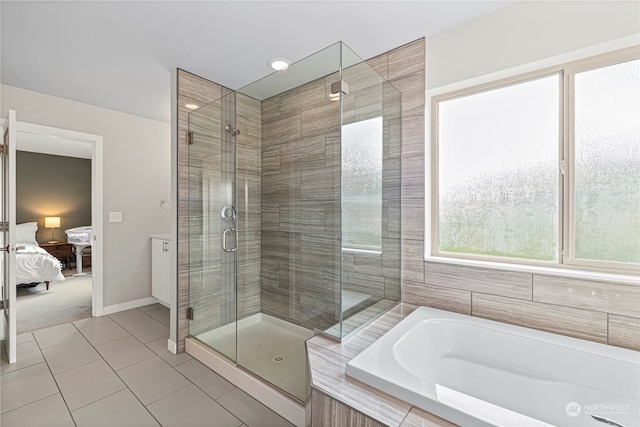 bathroom featuring independent shower and bath and tile patterned floors