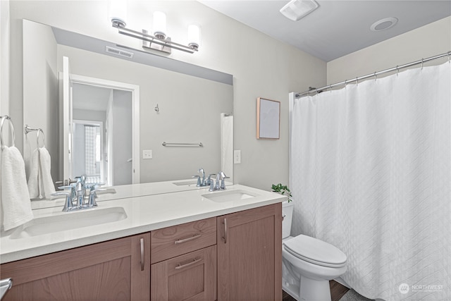 bathroom featuring toilet and vanity