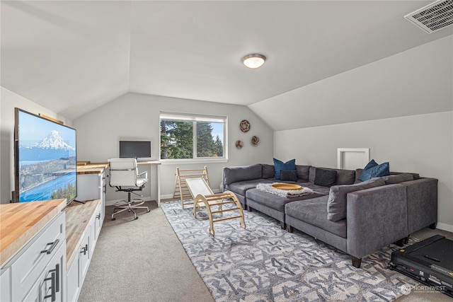 living room with vaulted ceiling and light colored carpet