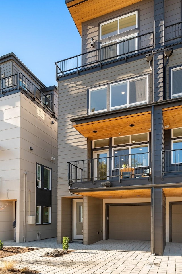 view of front of property with a balcony and a garage