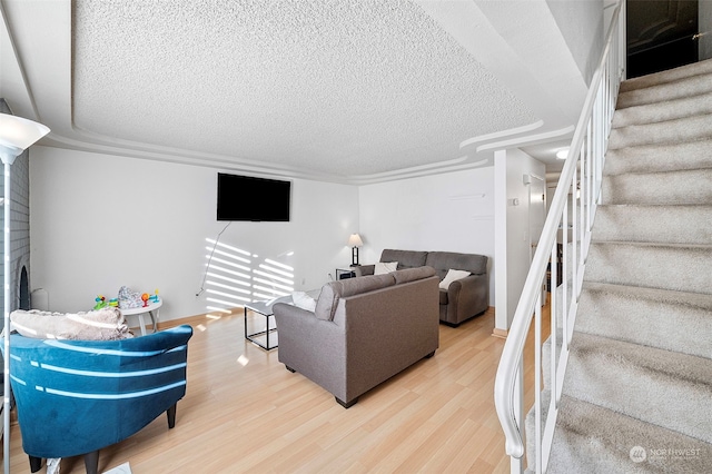 living room featuring hardwood / wood-style flooring and a textured ceiling