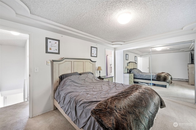 carpeted bedroom with a textured ceiling and a baseboard radiator