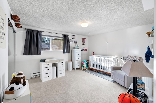 carpeted bedroom with a crib, baseboard heating, and a textured ceiling