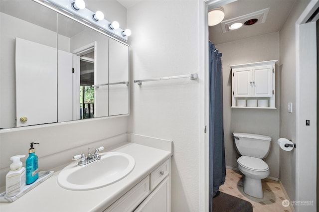 bathroom featuring toilet and vanity