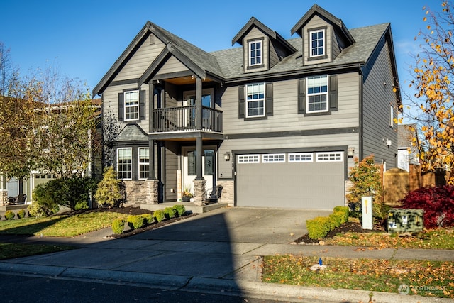 view of front of property with a balcony and a garage