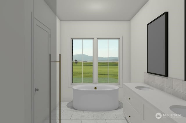 bathroom featuring a bathtub, vanity, tile patterned flooring, and a mountain view