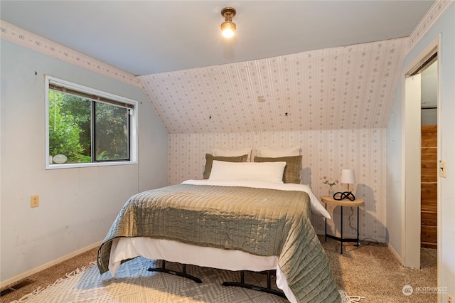 bedroom featuring lofted ceiling and carpet floors