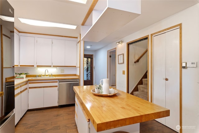 kitchen featuring white cabinetry, sink, dark hardwood / wood-style floors, butcher block countertops, and dishwasher