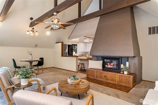 carpeted living room featuring high vaulted ceiling, beamed ceiling, ceiling fan, and a fireplace