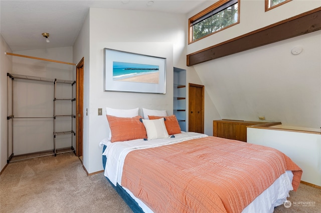 bedroom with lofted ceiling and light colored carpet