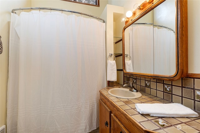 bathroom featuring backsplash and vanity